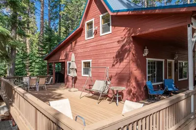 a wooden deck with chairs and a house at Dogwood Star Star Location Cozy Vibes in Shaver Lake