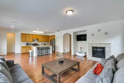 a living room with a couch and a table at 7 Mi to Lake Yosemite Family Home with Fenced Yard in Merced