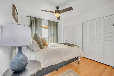a bedroom with a bed and a table with a lamp at Ranch Stay-A 240 acre Working Ranch in Granite Bay