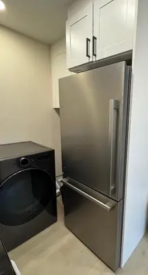 a kitchen with a stainless steel refrigerator and a dishwasher at 2 bed 1 bath special woodlake duplex A in Sacramento