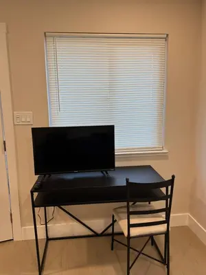 a black desk in a room with a window at 2 bed 1 bath special woodlake duplex A in Sacramento
