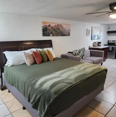 a bedroom with a large bed and a couch at The Getaway -6 miles from SNP in Three Rivers