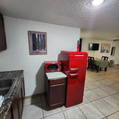 an old red refrigerator in a kitchen with a table at The Getaway -6 miles from SNP in Three Rivers