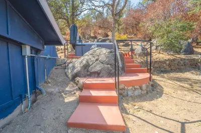 a set of stairs next to a building at Gateway To Sequoia River House in Three Rivers