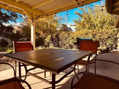 a wooden table and chairs on a patio at Magic Sequoia Spacious Home in Three Rivers