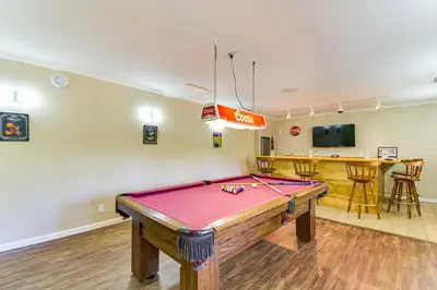 a pool table in a room with a bar at Game Room and Bar Wooded Pine Mountain Lake Retreat in Groveland