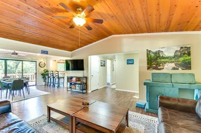 a living room with a wooden ceiling at Game Room and Bar Wooded Pine Mountain Lake Retreat in Groveland