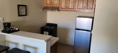 a kitchen with a refrigerator and a stove at Bishop Village Motel in Bishop