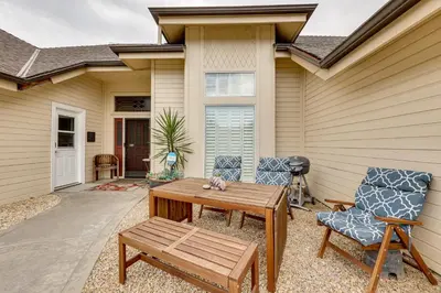 a patio with a wooden table and two chairs at Golf, Hike, Explore Apt 9 Mi to Dtwn Fresno! in Fresno
