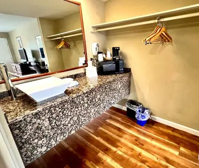 a bathroom with a counter with a sink and a mirror at Travelodge by Wyndham Reno in Reno