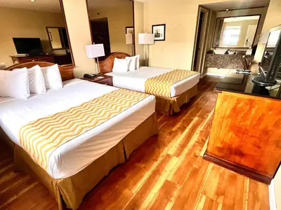 a hotel room with two beds and a television at Travelodge by Wyndham Reno in Reno