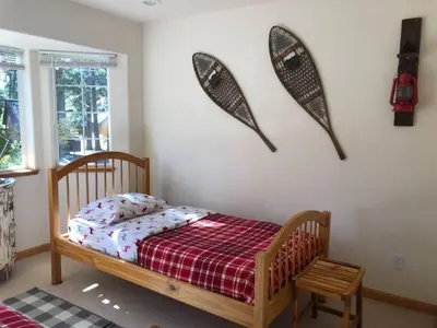 a bedroom with a bed with a red and white blanket at Large 3 Bedrooms Outdoor Seating in Tahoe Vista