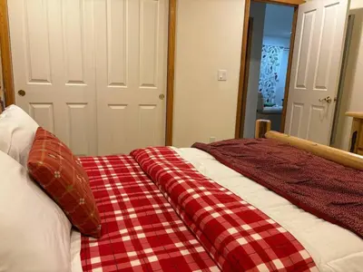 a bed with a red and white checkered blanket on it at Large 3 Bedrooms Outdoor Seating in Tahoe Vista
