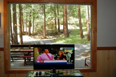 a flat screen tv sitting in a window at Ox Yoke in Wawona