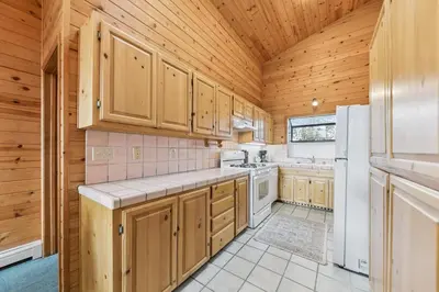 a kitchen with wooden cabinets and a white refrigerator at 589 Danube Drive condo in South Lake Tahoe
