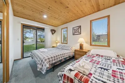 two beds in a room with a window at 587 Danube Drive condo in South Lake Tahoe