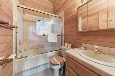 a bathroom with a tub and a sink and a toilet at 587 Danube Drive condo in South Lake Tahoe
