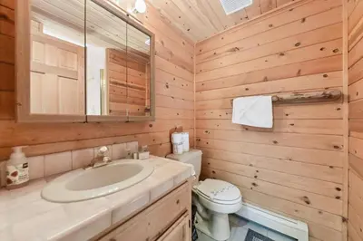 a bathroom with a sink and a toilet and a mirror at 587 Danube Drive condo in South Lake Tahoe