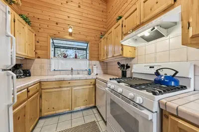 a kitchen with wooden cabinets and a white stove top oven at 587 Danube Drive condo in South Lake Tahoe