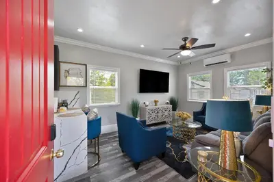 a living room with a couch and a table at Walk to UC Davis Medical Center! Duplex with Patio in Sacramento