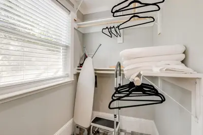 a bathroom with a towel rack and a surfboard at Walk to UC Davis Medical Center! Duplex with Patio in Sacramento