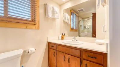 a bathroom with a sink and a mirror and a tub at Sleeps 20 2 Homes Near Ski Resort Beach Lake Access Pool Homewood in Tahoma