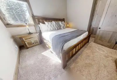 a small bedroom with a bed and a window at South Lake Escape Indoor Pool plus Movie Theater in South Lake Tahoe