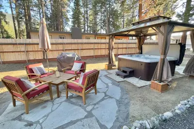 a patio with a gazebo and a table and chairs and a tub at Pine Ridge Retreat in Stateline