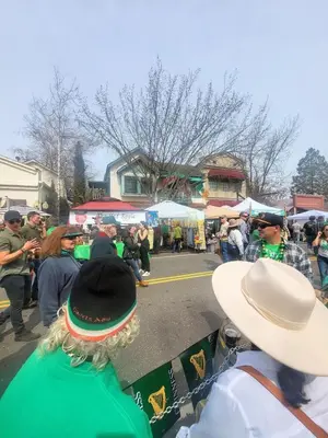 a crowd of people standing around in a market at Terrace On Main Street in Murphys