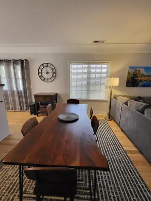 a living room with a wooden table and a couch at Terrace On Main Street in Murphys