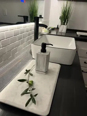 a counter with a bottle of soap on a cutting board at Terrace On Main Street in Murphys
