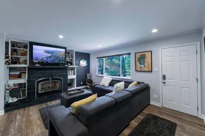 a living room with a couch and a tv at Private Woods - Cottage for 4 in South Lake Tahoe