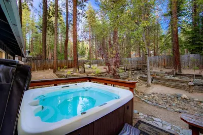 a jacuzzi tub in the middle of a yard at Private Woods - Cottage for 4 in South Lake Tahoe