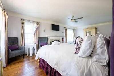 a bedroom with a white bed with a ceiling fan at Grand Wine Country 6BR Retreat Hot Tub & Views in San Martin