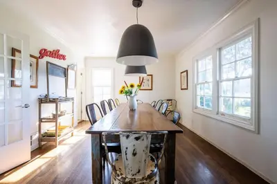 a dining room with a table with a vase of flowers at Grand Wine Country 6BR Retreat Hot Tub & Views in San Martin