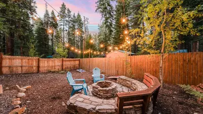 a backyard with a fire pit and chairs and a fence at Outdoor Dining Backyard Trails Nearby Cedar Hollow Retreat by AvantStay in Tahoma