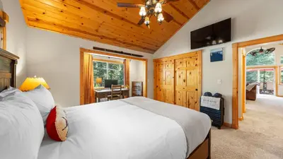 a bedroom with a large white bed and a desk at Outdoor Dining Backyard Trails Nearby Cedar Hollow Retreat by AvantStay in Tahoma