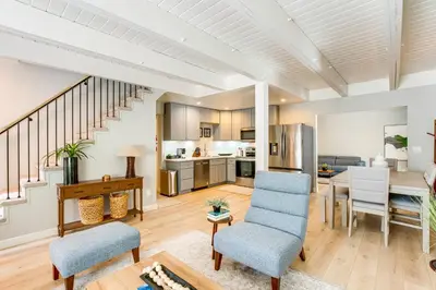 a living room with a table and chairs and a kitchen at Hot Tub and Game Room Luxe Cabin, Day Trip to Tahoe in Pollock Pines