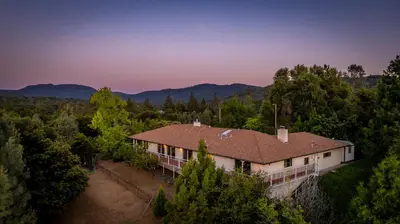 an aerial view of a house in the woods at Sierra View Retreat with Newly Installed Hot tub! in Oakhurst