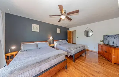 a bedroom with two beds and a ceiling fan at Sierra View Retreat with Newly Installed Hot tub! in Oakhurst