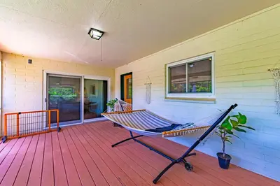 a hammock on a porch of a house at Sierra View Retreat with Newly Installed Hot tub! in Oakhurst