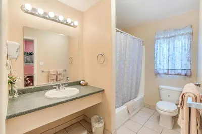 a bathroom with a sink and a toilet at Los Banos Motel in Los Banos