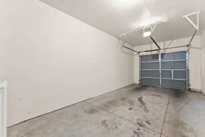 an empty room with white walls and a concrete floor at Luxury King Suite by the Lake - Entire Place in Sparks