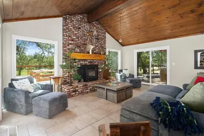 a living room with couches and a fireplace at WoodUStau in Coarsegold