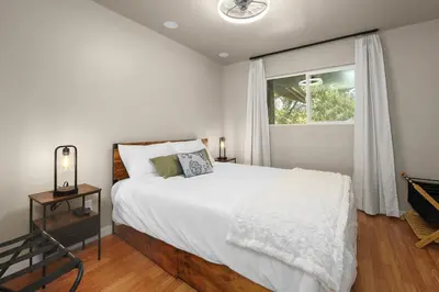 a bedroom with a white bed and a window at WoodUStau in Coarsegold