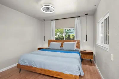 a bedroom with a large bed and a window at WoodUStau in Coarsegold