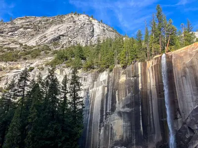 a waterfall on the side of a mountain at Boom Chalet Yosemite in Oakhurst