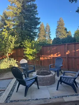 three chairs and a fire pit in a backyard at Contemporary, newly renovated and great location in Fresno
