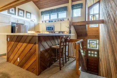 a kitchen with wood paneling and a bar in a house at 3 Bedrooms + Loft townhome in Snowcreek Phase 3, Private Pool Table Sleeps 6 Guests, Dog Friendly in Mammoth Lakes