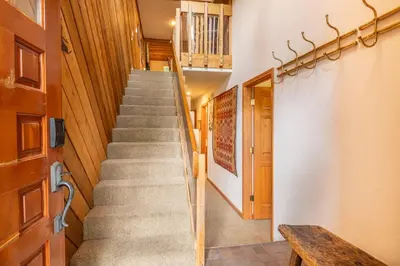 a staircase in a house with a wooden door at 3 Bedrooms + Loft townhome in Snowcreek Phase 3, Private Pool Table Sleeps 6 Guests, Dog Friendly in Mammoth Lakes